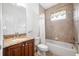 Bathroom with granite vanity and shower/tub combo at 1008 Blue Heron Way, Tarpon Springs, FL 34689
