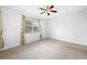 Spacious bedroom with carpeted floor and ceiling fan at 1008 Blue Heron Way, Tarpon Springs, FL 34689