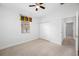 Bedroom with ceiling fan, window, and double doors to closet at 1008 Blue Heron Way, Tarpon Springs, FL 34689