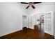 Bedroom with hardwood floors, double door closet and access to another room at 1008 Blue Heron Way, Tarpon Springs, FL 34689
