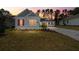 Craftsman style home with a welcoming front porch at dusk at 19581 Sheltered Hill Dr, Brooksville, FL 34601