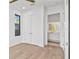Bright bedroom with wood floors, a window, and an adjacent bathroom at 2201 N Glenwood Dr, Tampa, FL 33602
