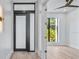 Modern entryway featuring wood floors, a contemporary light fixture, and large windows at 2201 N Glenwood Dr, Tampa, FL 33602