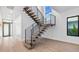 Modern staircase featuring wood treads, steel railings, and an open design in a brightly lit home at 2201 N Glenwood Dr, Tampa, FL 33602
