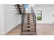 Straight-on view of a modern staircase featuring wood treads and steel railings in a well-lit home at 2201 N Glenwood Dr, Tampa, FL 33602