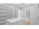 Custom walk-in closet with open shelving, drawers, and central island, designed for easy access and organization at 2201 N Glenwood Dr, Tampa, FL 33602