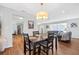 Bright dining area with a wood table and chairs, hardwood floors, and access to the living room at 13106 Pebble Beach Cir, Hudson, FL 34667