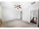 Bright and airy bedroom with hardwood floors and access to hallway at 1008 Blue Heron Way, Tarpon Springs, FL 34689
