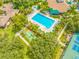 Community pool, tennis court, and bocce ball area at 1008 Blue Heron Way, Tarpon Springs, FL 34689