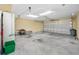 Garage with concrete floor and storage at 1008 Blue Heron Way, Tarpon Springs, FL 34689