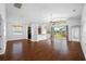 Open concept living and kitchen area with hardwood floors and access to backyard at 1008 Blue Heron Way, Tarpon Springs, FL 34689