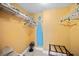 Small laundry room with shelving and ironing board at 14300 Gulf Blvd # 206, Madeira Beach, FL 33708