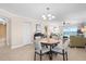 Open concept dining area with ocean view and four chairs at 14300 Gulf Blvd # 206, Madeira Beach, FL 33708