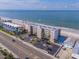Aerial view of beachfront building with pool and parking at 14300 Gulf Blvd # 206, Madeira Beach, FL 33708