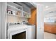 Well-equipped laundry room with washer, dryer, and ample storage shelves at 14300 Gulf Blvd # 206, Madeira Beach, FL 33708