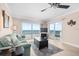 Living room with ocean view and sliding glass doors to balcony at 14300 Gulf Blvd # 206, Madeira Beach, FL 33708