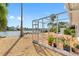 Relaxing backyard oasis with a screened patio, wooden deck, and lush greenery at 11220 9Th E St, Treasure Island, FL 33706