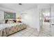 Bright bedroom with king-size bed and access to hallway at 11220 9Th E St, Treasure Island, FL 33706