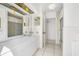 Double vanity, tiled floors, and access to shower at 11220 9Th E St, Treasure Island, FL 33706