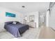 Spacious bedroom with a double bed, dresser, and access to a full bathroom and hallway at 11220 9Th E St, Treasure Island, FL 33706