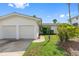 White two-car garage, nicely landscaped front yard at 11220 9Th E St, Treasure Island, FL 33706
