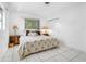 King-size bed, ample natural light, and tiled floor at 11220 9Th E St, Treasure Island, FL 33706