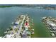 Aerial view of a house on the waterfront with a private dock and beautiful landscaping at 11220 9Th E St, Treasure Island, FL 33706