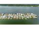 Wide aerial view of a waterfront neighborhood, highlighting various properties and boats at 11220 9Th E St, Treasure Island, FL 33706