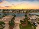 Stunning aerial view of waterfront property with beautiful sunset at 11220 9Th E St, Treasure Island, FL 33706