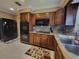 Kitchen features dark wood cabinets, granite countertops, and stainless steel appliances at 3912 Fontainebleau Dr, Tampa, FL 33634