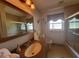 Bathroom with single sink vanity, shower/tub combo, and a mirror at 3912 Fontainebleau Dr, Tampa, FL 33634