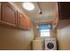 Laundry room with washer, dryer, and upper cabinets at 3912 Fontainebleau Dr, Tampa, FL 33634