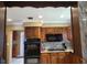 View of kitchen with granite countertops, dark wood cabinets, and a double oven at 3912 Fontainebleau Dr, Tampa, FL 33634