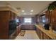 Large kitchen with granite countertops, dark wood cabinets, and stainless steel appliances at 3912 Fontainebleau Dr, Tampa, FL 33634