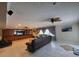 Living room with fireplace, leather furniture, and a view of the backyard at 3912 Fontainebleau Dr, Tampa, FL 33634