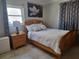 Bedroom with a wooden bed frame and neutral colored bedding and decor at 3912 Fontainebleau Dr, Tampa, FL 33634