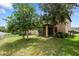 Landscaped backyard with screened porch and fenced area at 15250 Anguilla Isle Ave, Tampa, FL 33647