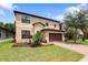 Two-story house with a two-car garage and landscaped yard at 15250 Anguilla Isle Ave, Tampa, FL 33647