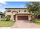 Two-story house with a two-car garage and landscaped yard at 15250 Anguilla Isle Ave, Tampa, FL 33647