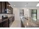 Modern kitchen with stainless steel appliances and granite countertops at 15250 Anguilla Isle Ave, Tampa, FL 33647