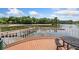 Relaxing lake view with a wooden deck and seating area at 15250 Anguilla Isle Ave, Tampa, FL 33647
