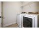 Bright laundry room with washer, dryer, and shelving at 15250 Anguilla Isle Ave, Tampa, FL 33647