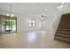 Spacious living room with tile floors and a staircase at 15250 Anguilla Isle Ave, Tampa, FL 33647