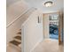 Hallway with stairway leads to the garage, featuring neutral decor and tile flooring at 6240 Bayside Dr, New Port Richey, FL 34652