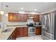 Beautiful kitchen with granite countertops, stainless steel appliances, and wooden cabinets, perfect for cooking and entertaining at 6240 Bayside Dr, New Port Richey, FL 34652