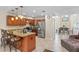 Spacious kitchen with an island, granite countertops, stainless steel appliances, and a connected dining area for easy entertaining at 6240 Bayside Dr, New Port Richey, FL 34652
