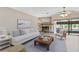 Cozy living room features a stone fireplace, comfortable seating, and sliding glass doors that create an inviting, relaxing atmosphere at 6240 Bayside Dr, New Port Richey, FL 34652