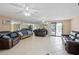 Spacious living room features tile flooring, plenty of seating, and sliding glass doors at 6240 Bayside Dr, New Port Richey, FL 34652