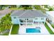 Aerial view of two-story house, pool, and landscaped backyard at 83 Palm Blvd, Dunedin, FL 34698