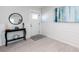 Welcoming entryway with hardwood floors, white wainscoting, and a round mirror at 83 Palm Blvd, Dunedin, FL 34698